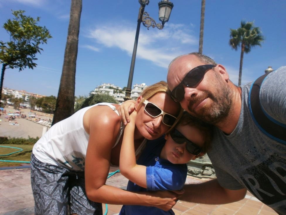 Enjoying Puerto Banus. Family hug on a promenade, Marbella, Spain