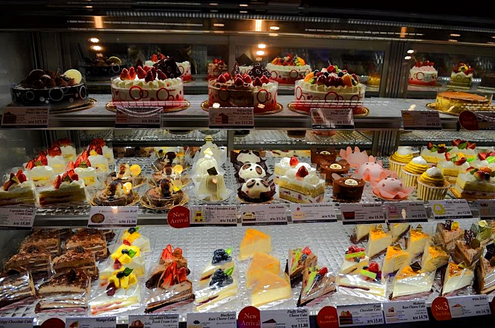 Sweet delicacies in Suria Shopping Mall. Variety of cakes brilliantly decorated