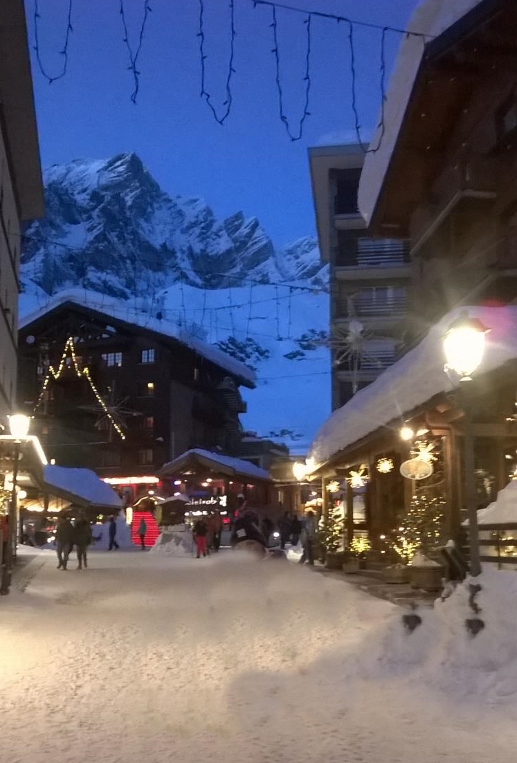 Night charm of Cervinia. city center lit up and full of snow
