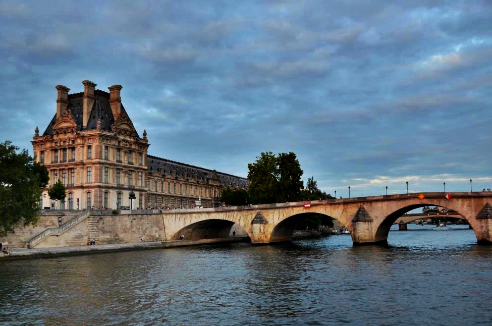 Seine River with a bridge and Louvre Museum facade on the left