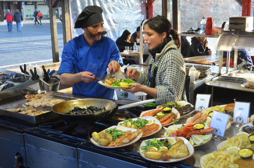 Chef is preparing fresh sea food portions, Bergen fish market