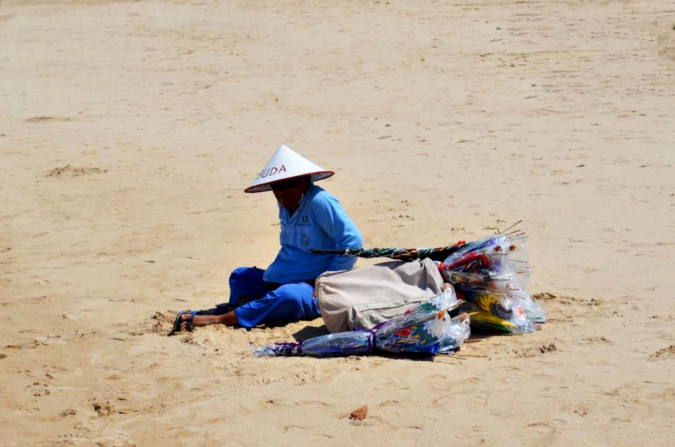 Local kite vendor sitting on Nusa Dua Beach