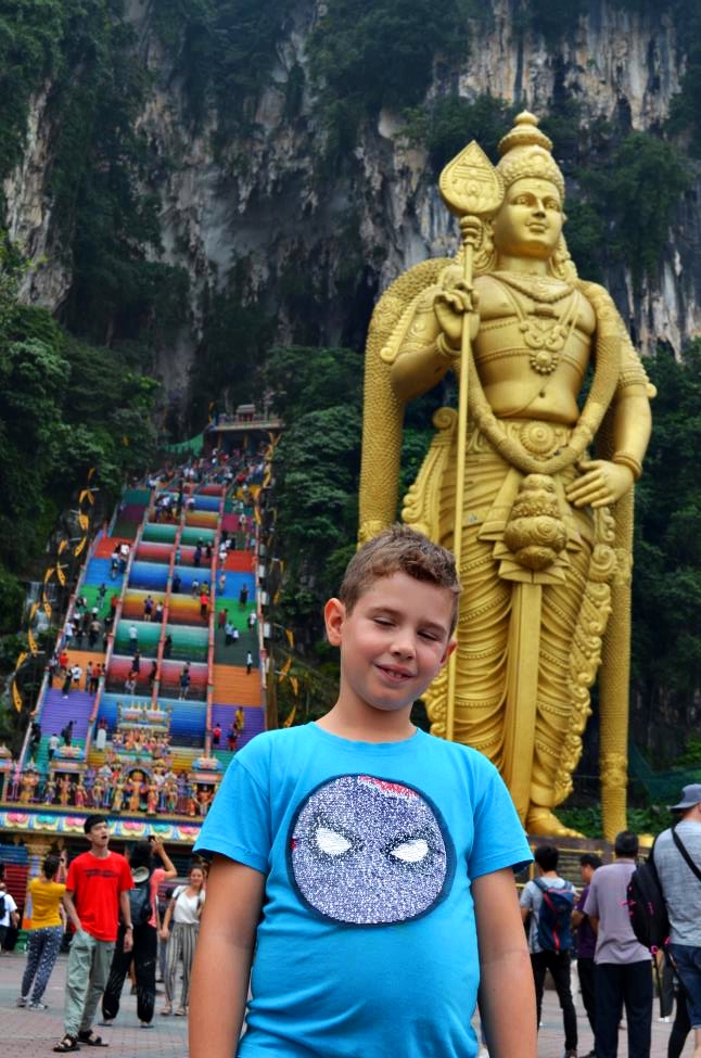 Mateja is in front of Batu Caves entrance with Lord Murugan giant statue