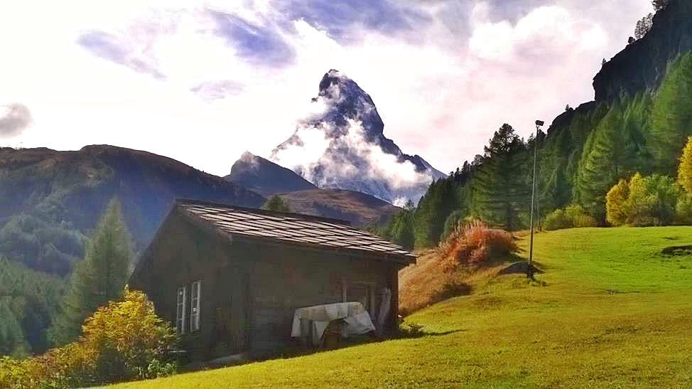 Old mountain hut with cloudy Matterhorn behind