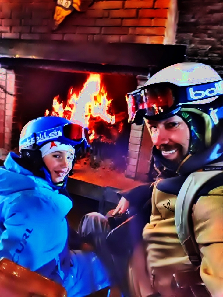 Mateja and his dad Jonnie on a ski break in a mountain hut and a fire to warm them up