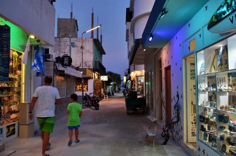 Evening stroll through a street on Maafushi island with interesting souvenir shops around