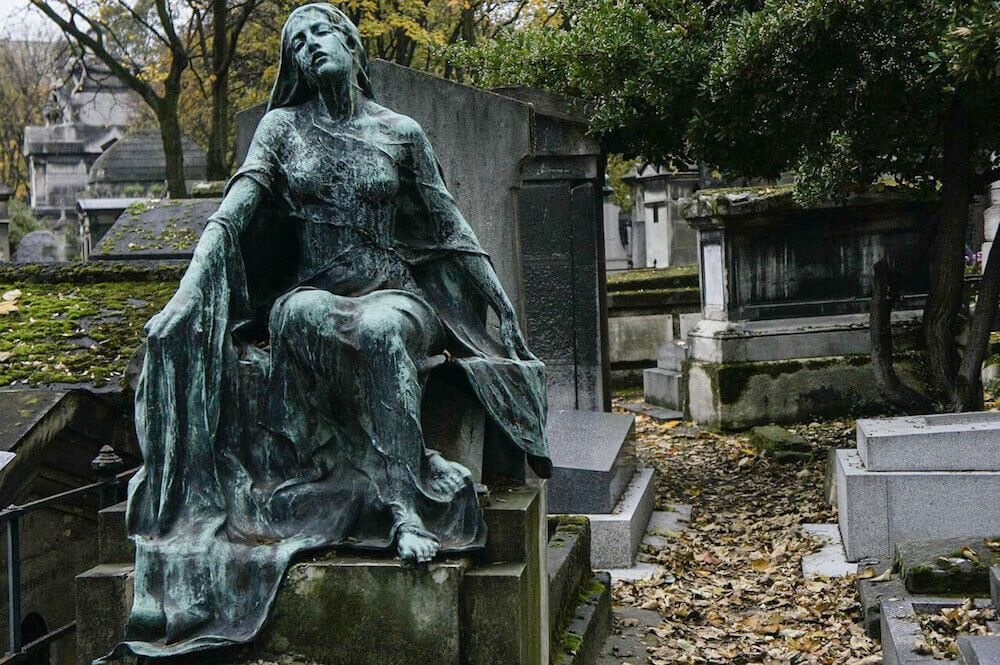 Beautiful bronze female funerary sculpture decorating one of the tombs on Montmartre Cemetery