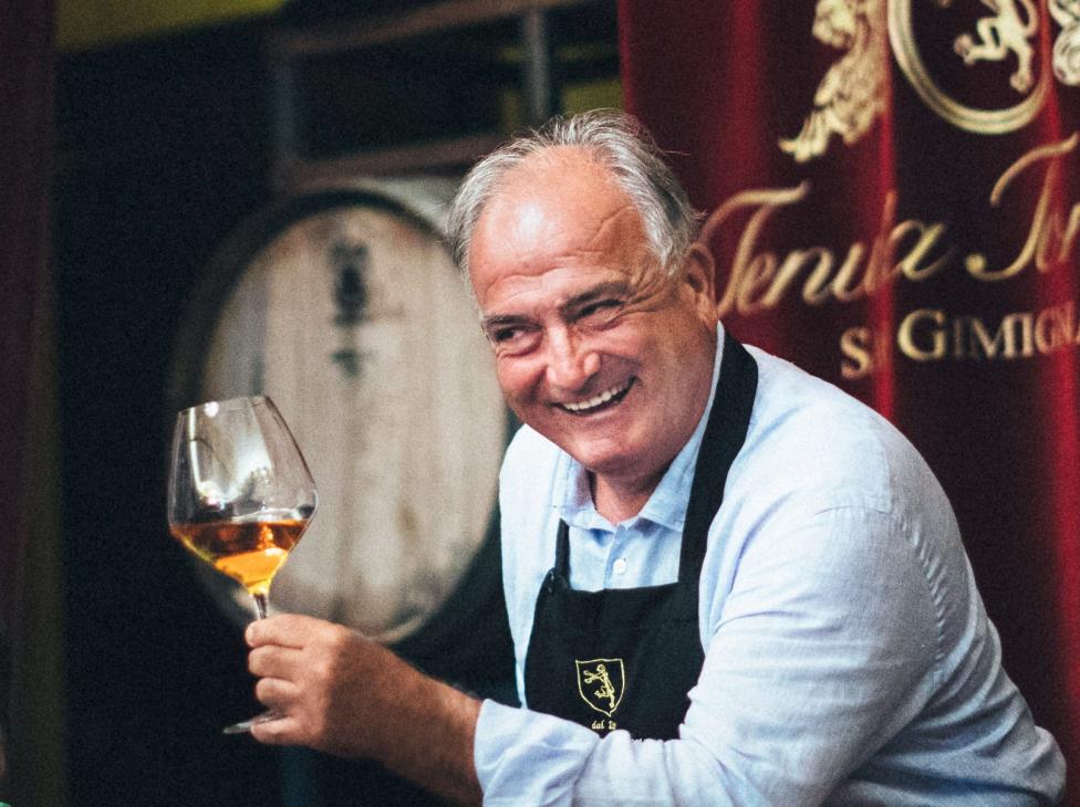 Tenuta Torciano owner cheers with a glass of sweet wine Vinsanto with a smile on his face