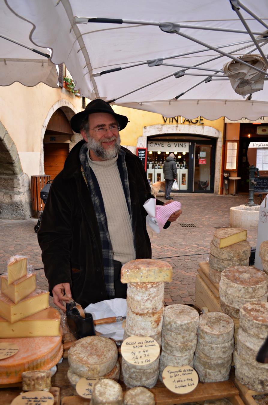 Local vendor in Annecy selling iconic Reblochon cheese